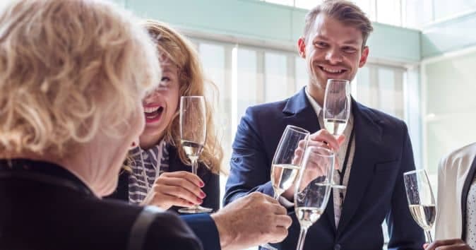 people drinking and clinking glasses