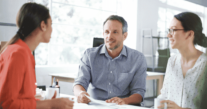 A small group of employees working together in an office