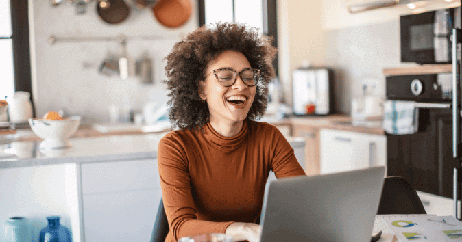 a woman laughing in fun virtual happy hour