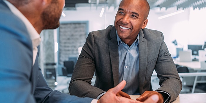 two business men discuss strategic goals for employee performance