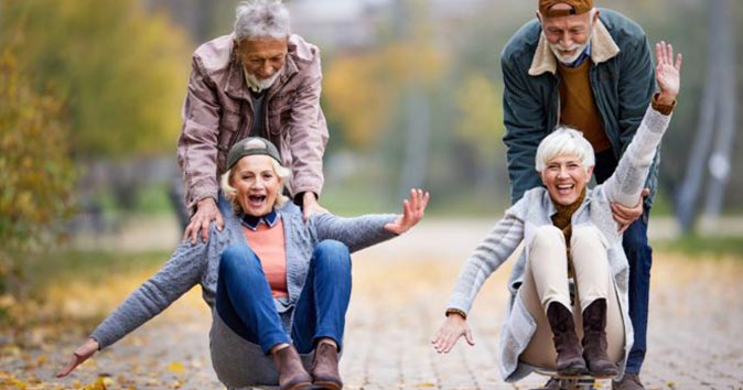 older couples playing with skateboards