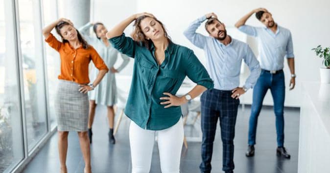 A bunch of employees attending in-office stretching session