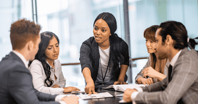 business leader reviewing general guidelines for inclusive language with team
