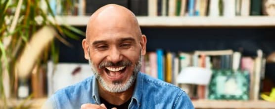 man smiling, demonstrating why emotional wellness in the workplace is important