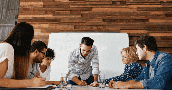 A young stakeholder in a meeting with his team