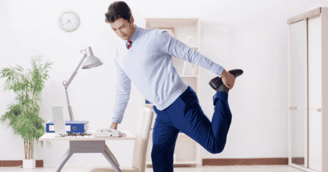 A man stretching his arms to reduce stress and improve office well-being