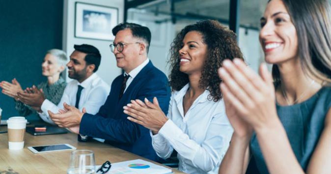 employees clapping during a meeting