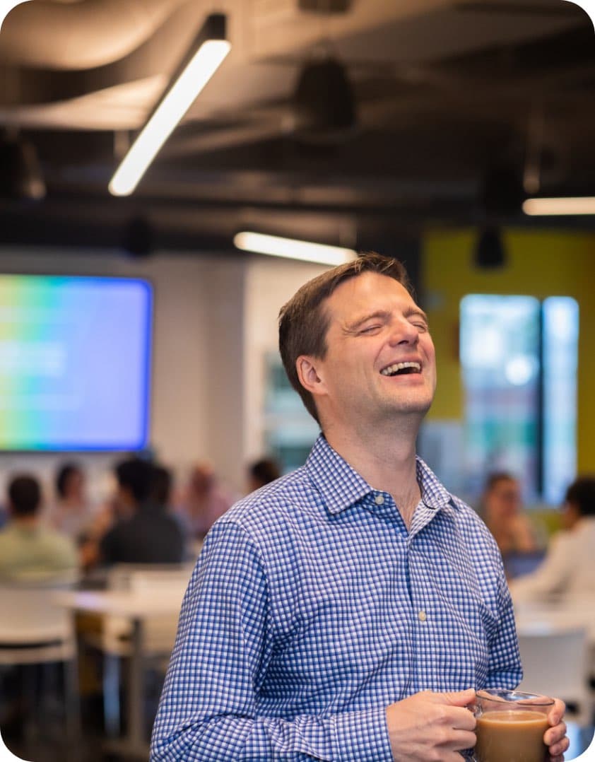 Eric Mosley in the office cafe with a coffee