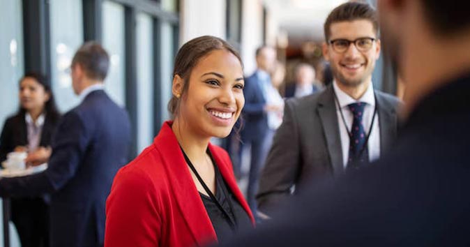 Men and women talking and smiling.