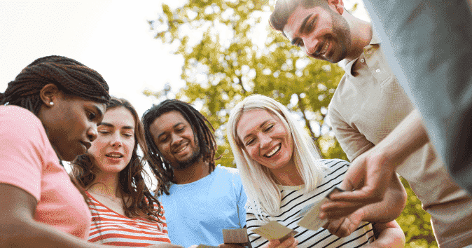 a team playing with cards as it's the most popular outdoor team building activities