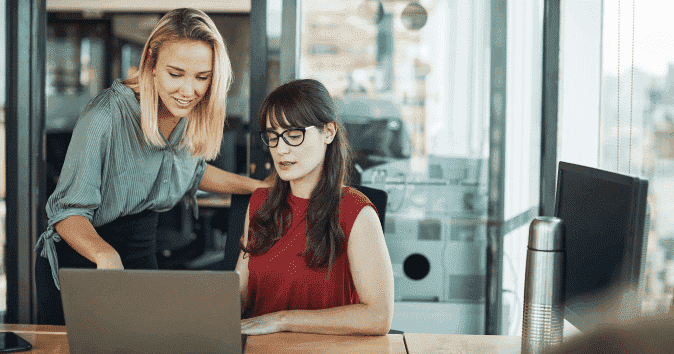 A young female manager giving feedback and coaching an employee
