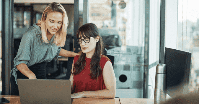 A young female manager giving feedback and coaching an employee