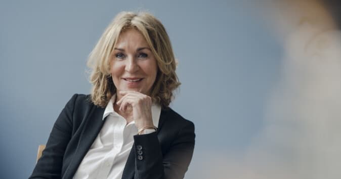 Woman smiling towards the viewer.