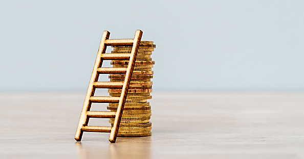 coins with tiny ladder symbolizing pay equity in the workplace