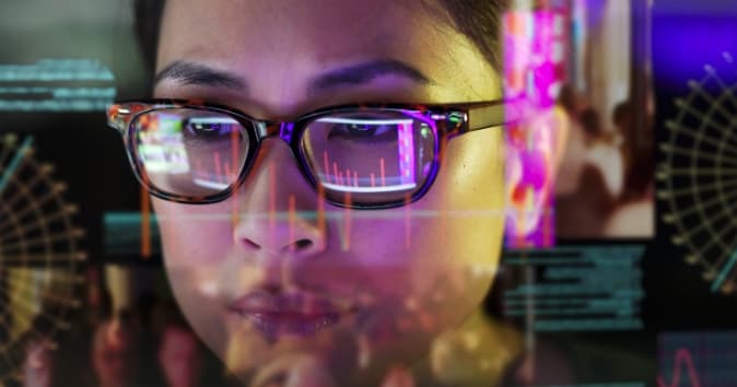 Woman looking at a screen with data overlayed on the image.