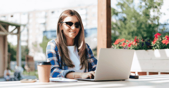 A young smiling woman working outside