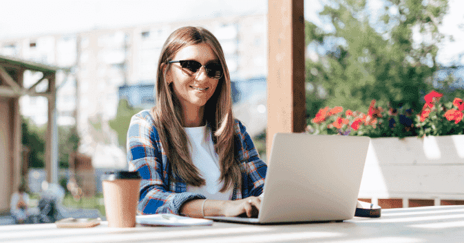 A young smiling woman working outside
