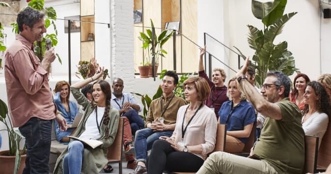 Meeting of people in a large room.