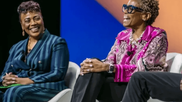 Two guests on a stage sitting in chairs