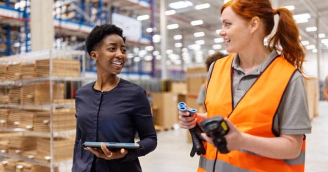 Two people working in the warehouse.