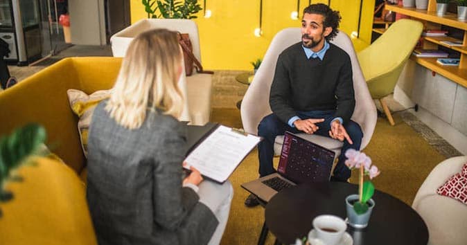 Two employees sitting and discussing