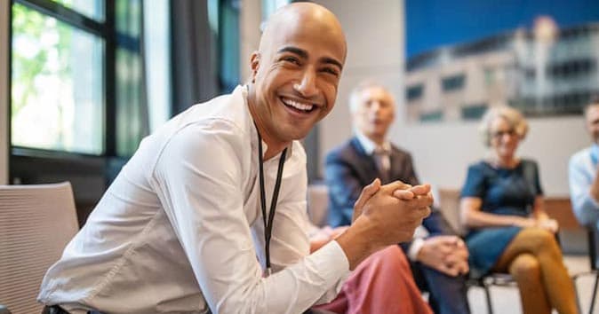 A person sitting on a chair and laughing