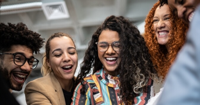 Group of diverse people smiling and celebrating.