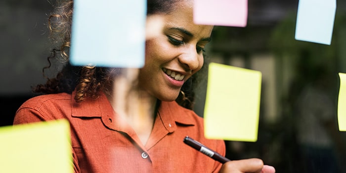 woman working on problem solving with sticky notes