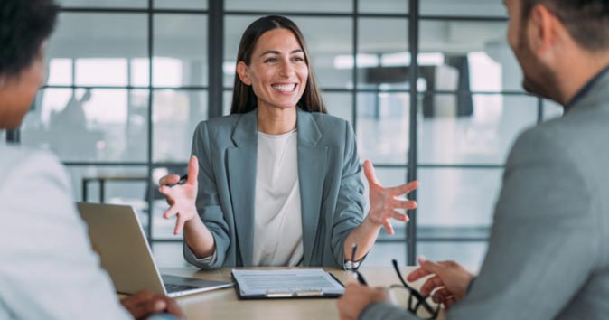 women laughing and talking to other people