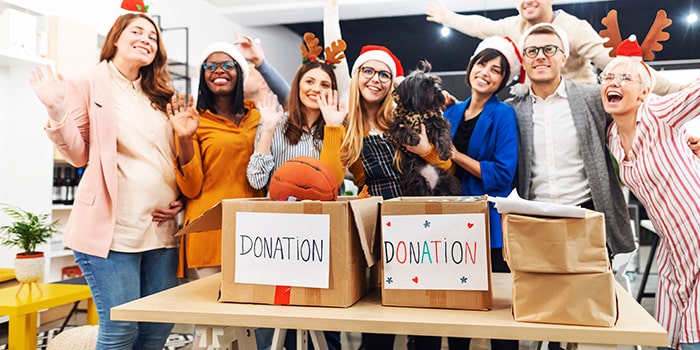 employees take a group photo at a charity drive