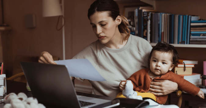mom working with baby on lap