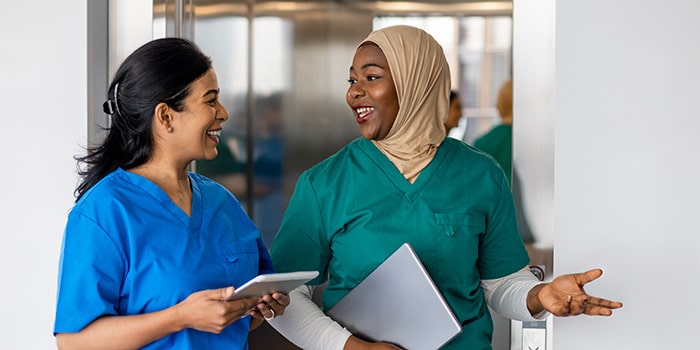 healthcare workers exchanging real time feedback in the office hallways