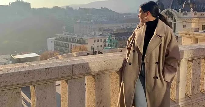An employee looks over the scenic city from a porch