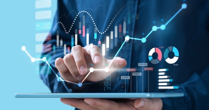 Person holding a tablet with data graphics overlayed over image.