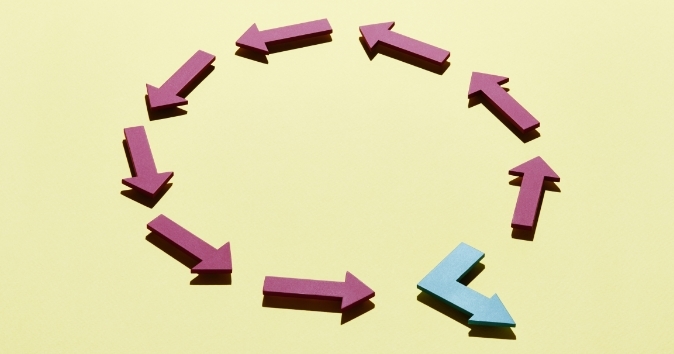 Circle of arrows with one breaking off the path.