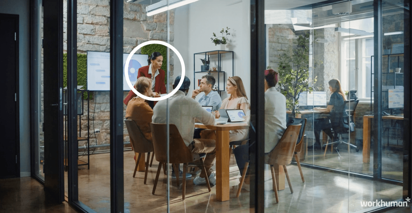 An image of an office highlighting a single office worker in a group